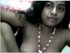 On livecam, a lewd, dilettante Indian nympho with enormous breasts smiles at me.